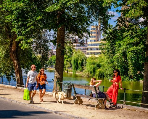 People walking in the city park enjoying sunny day